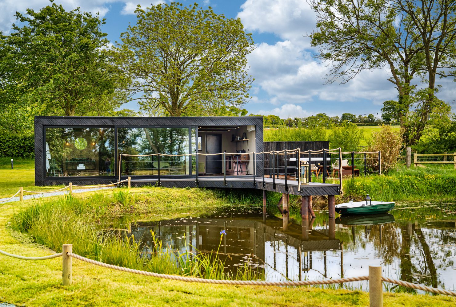 The Rusty Boathouse waterside glamping cabin on a lake with rowing boat, Pantcefn, Ceredigion
