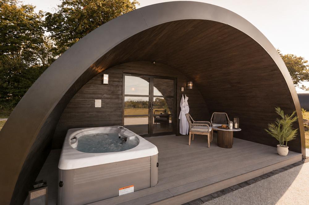 The Hog Hut exterior in daylight, arch open to the hot tub and deck