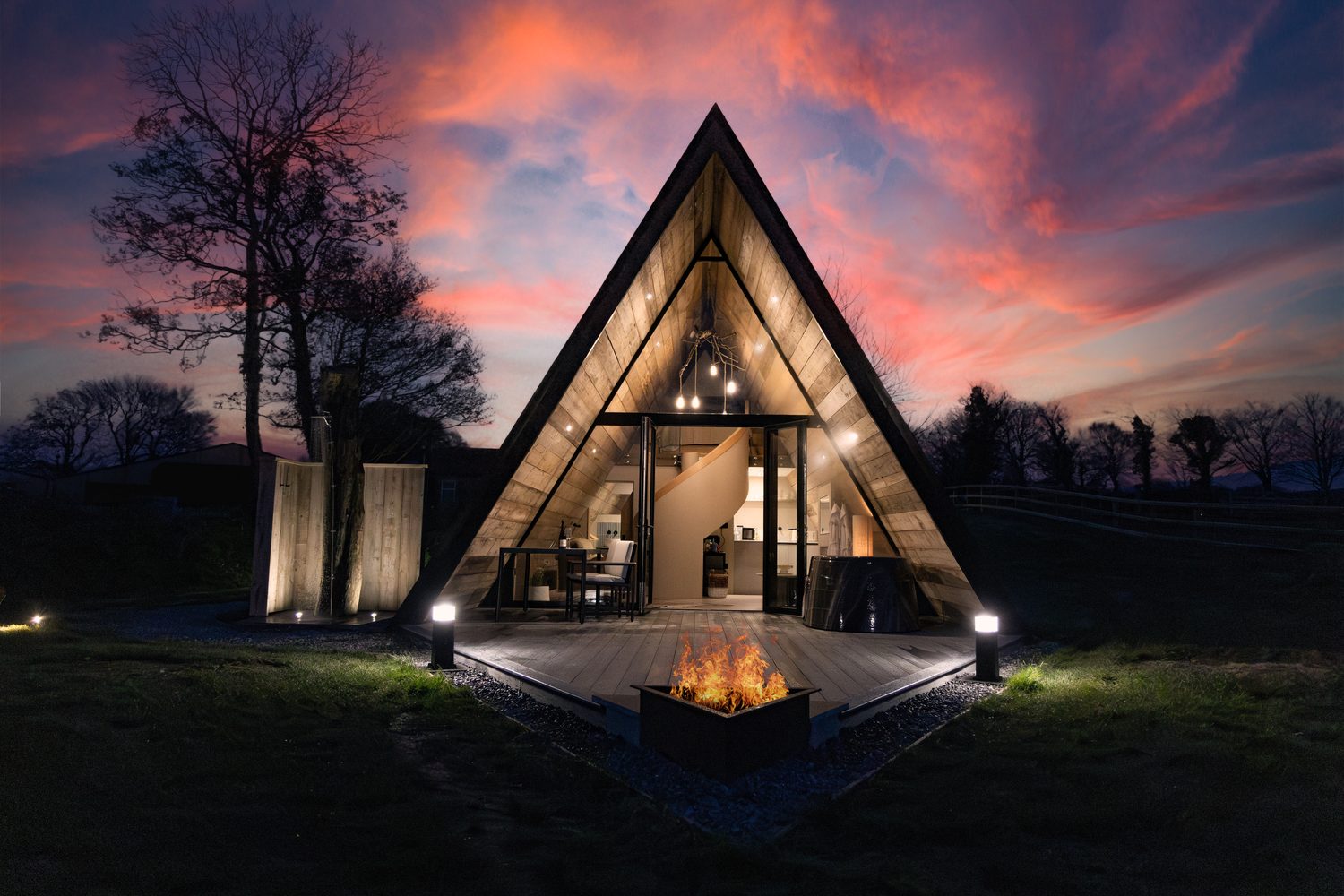 The Tri-Pod A-frame glamping pod at dusk with fire pit, Pantcefn, Ceredigion
