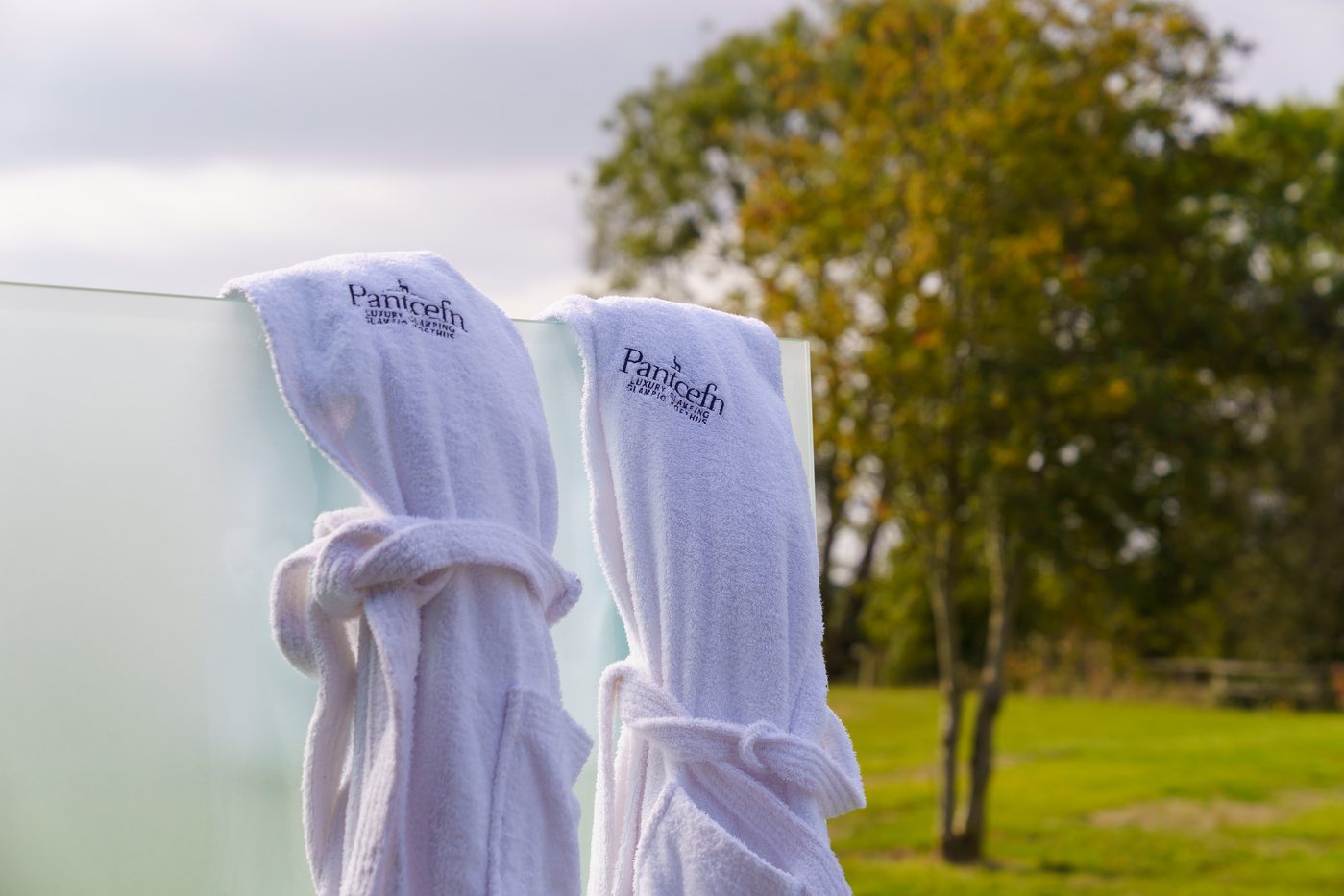 Pantcefn branded robes on the privacy screen outside the Piglet Pod