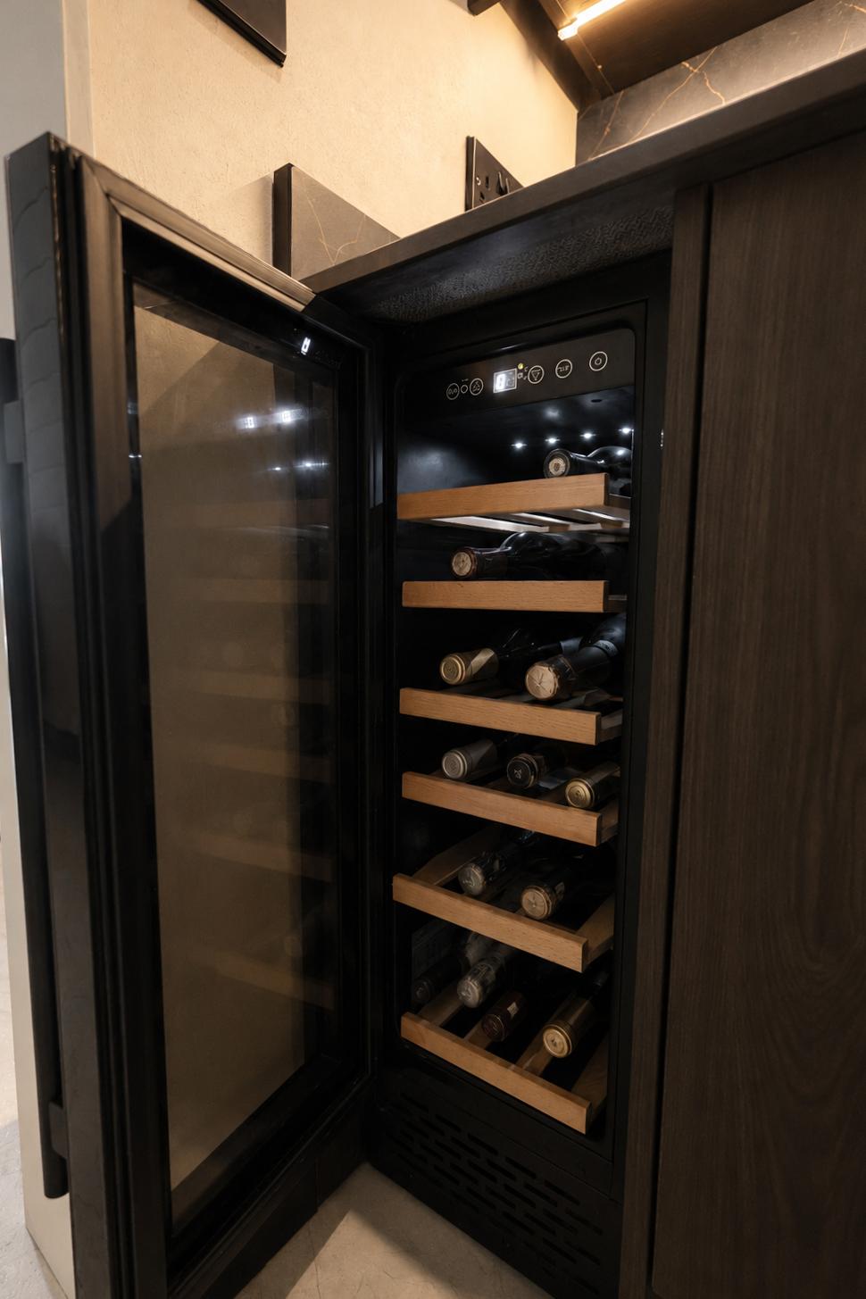 Integrated wine fridge fully stocked, tucked into the kitchen cabinetry