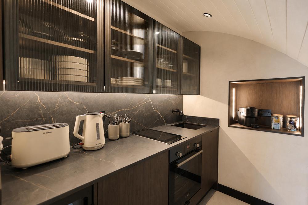 Kitchen counter with kettle and toaster against dark stone
