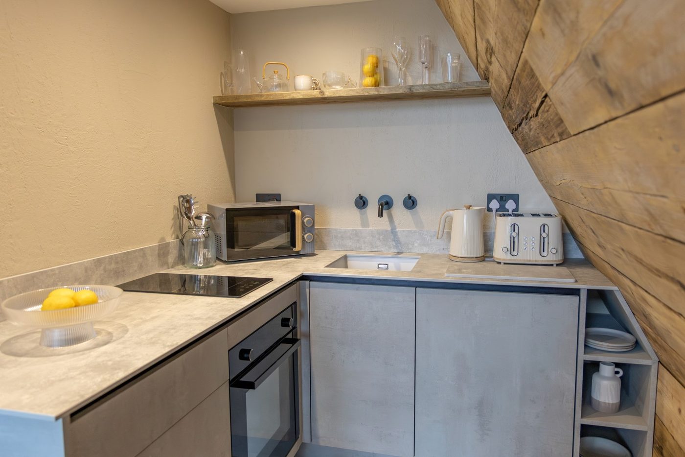 Fully equipped kitchen inside the Tri-Pod with concrete-effect cabinetry