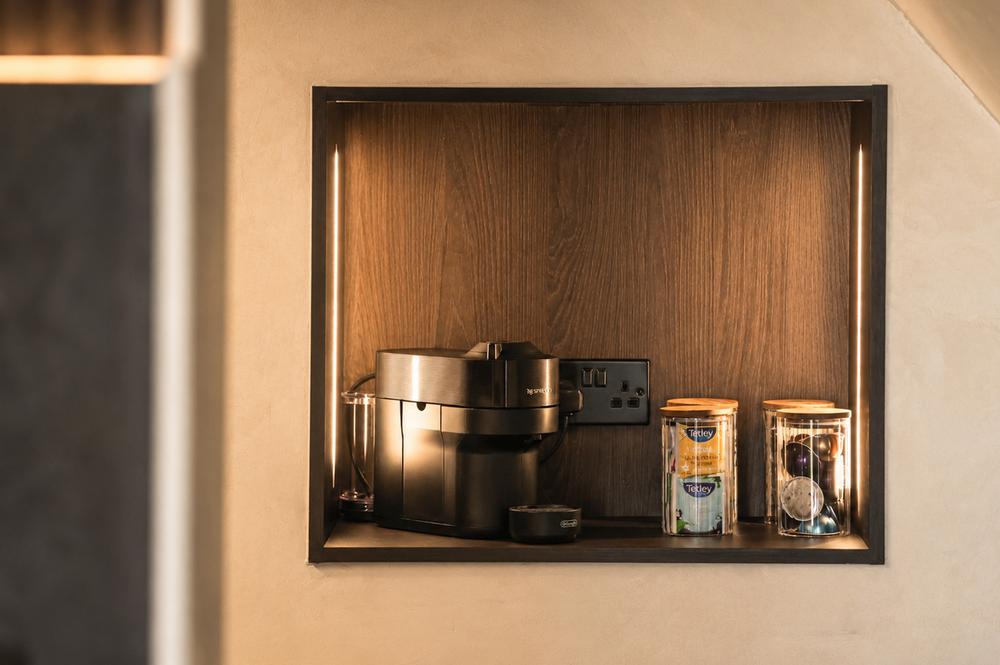 Nespresso machine and tea station built into the kitchen alcove